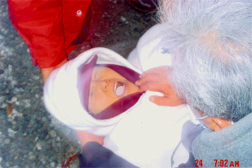 Julia Kim in ecstasy miraculously receives the Most Holy Body, supported by two faithful