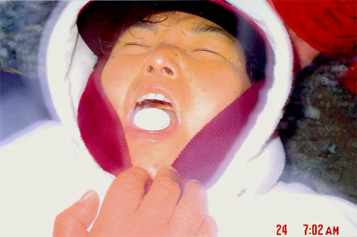 Julia Kim in ecstasy miraculously receives the Most Holy Body, supported by two faithful