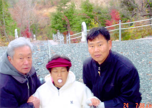 Julia Kim in ecstasy miraculously receives the Most Holy Body, supported by two faithful